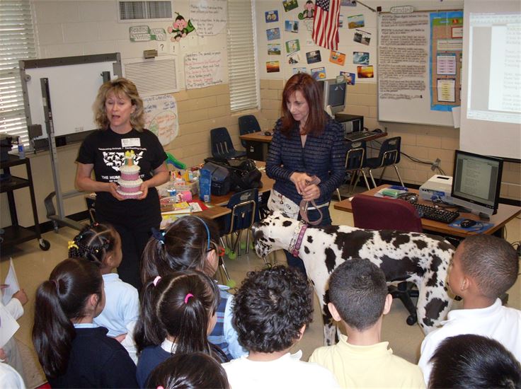 Debra Berger teaches in a classroom with a dog